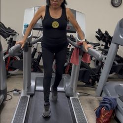 Nu Image Now Wellness Center - Lutskie reverse walking in treadmill.  Also pic with personal trainer Ikumi after Lutskie lost 22 lbs.