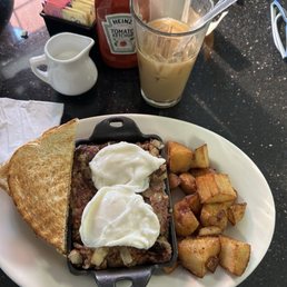2 poached eggs on handmade hash and roasted potatoes.