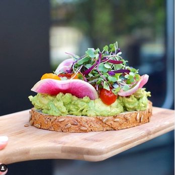 Toastique - a person holding a wooden board with a sandwich on it - Juice Bars & Smoothies Near Me - Washington, DC, District of Columbia Toastique - a person holding a wooden board with a sandwich on it - Juice Bars & Smoothies Near Me - Washington, DC, District of Columbia