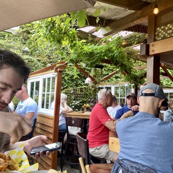 Nor'East Beer Garden - Seating area. Lots of greenery and fun vibes all around. Windowed separators between tables add to privacy (+ Covid-conscious) - Bars Near Me - Provincetown, Massachusetts
