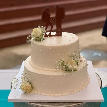 Satvik Eggless Bakery - A hiking themed topper for chocolate cake covered with while cream and fresh flowers. Very simple and elegant looking cake! - Bakeries Near Me - Dublin, California