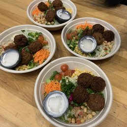 Falafel bowl with spinach hummus and tahini sauce