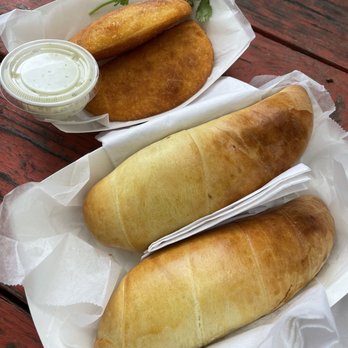Cachitos512 - Chicken empanada above and ham and cheese cachito below - Venezuelan Near Me - Austin, Texas