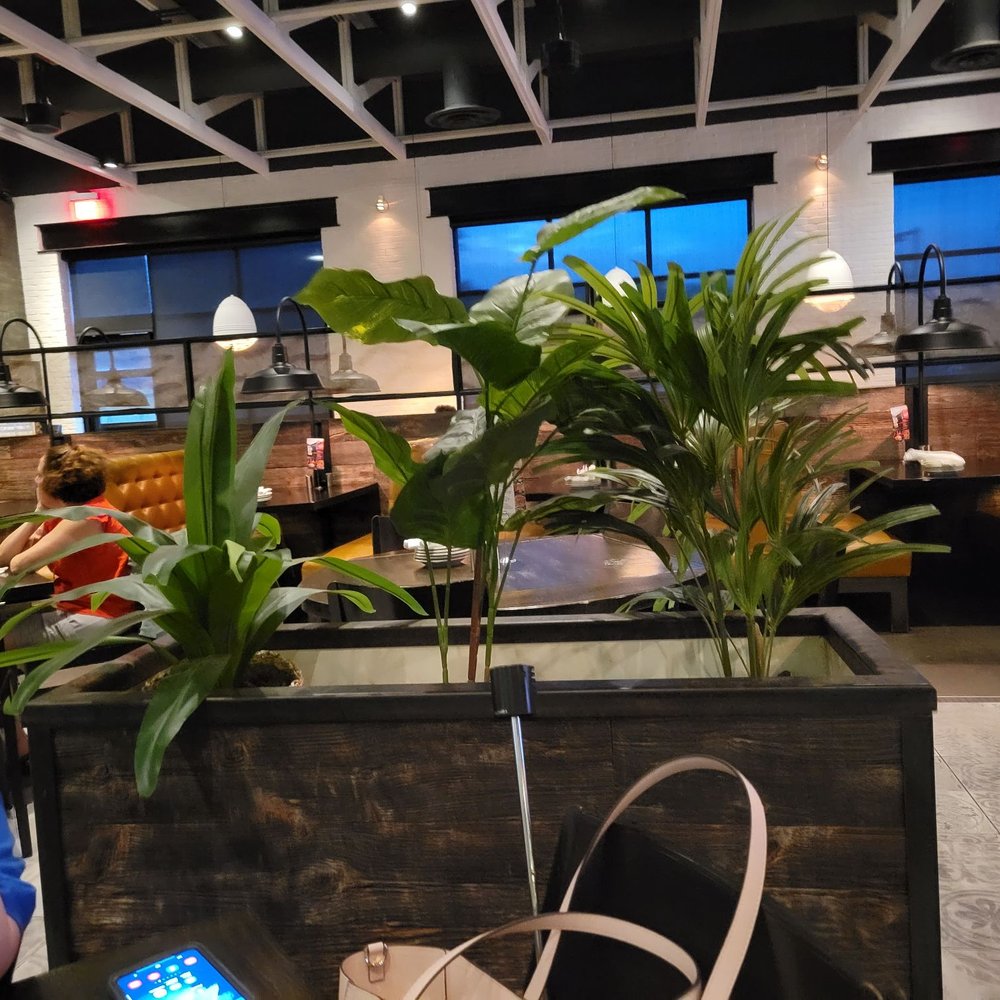 Not Your Average Joe's - Waltham - a woman sitting at a table - New American Near Me - Waltham, Massachusetts Not Your Average Joe's - Waltham - a woman sitting at a table - New American Near Me - Waltham, Massachusetts