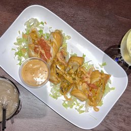 The delicious southwestern rolls for app. Along with a drink of wine and a perfect Long Island. The delicious southwestern rolls for app. Along with a drink of wine and a perfect Long Island.
