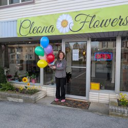 Cleona Flowers - Dara in front of shop on opening day, April 1, 2025.