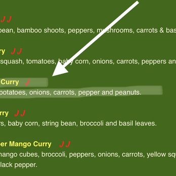 Wild Ginger - A green menu displays curry options like Massaman Curry, with descriptions and symbols indicating spice levels. - Thai Near Me - Norwell, Massachusetts