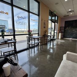 Alani Bakery - Sitting area. Small, with a total of three two-seater tables and a sofa.