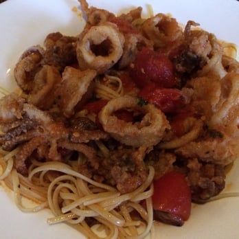 Amici - Fried calamari over linguini with pomodoro sauce - Italian Near Me - Mount Sinai, New York Amici - Fried calamari over linguini with pomodoro sauce - Italian Near Me - Mount Sinai, New York