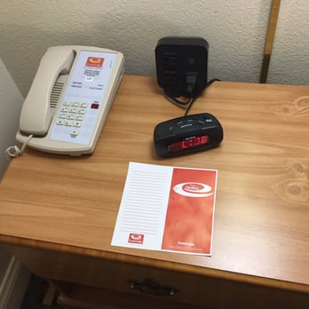 Econo Lodge - Bedside table with clock, telephone, AC outlets and USB ports. - Hotels Near Me - Walterboro, South Carolina
