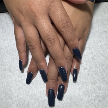 Luv Ur Nails - Acrylic fill in and massage - Close-up of two hands with dark blue acrylic nails, placed on a white surface, showing well-manicured nails and skin texture. - Nail Salons Near Me - Naperville, Illinois