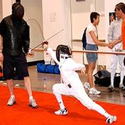 Daniel Hondor, head coach at Olympia Fencing Center, preparing a young fencer for competition.