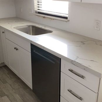 Builder's Mark Home Improvement - a kitchen with white cabinets and marble countertops - Home Decor Near Me - San Antonio, Texas Builder's Mark Home Improvement - a kitchen with white cabinets and marble countertops - Home Decor Near Me - San Antonio, Texas