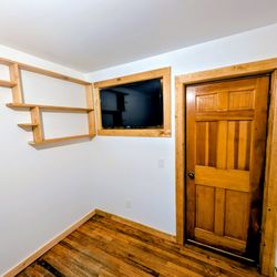 Bret Michael Davis Carpentry & Woodwork - Full room remodel. We replaced the wood panel walls with sheetrock, all new trim and a custom recessed TV niche and custom matching shelf.