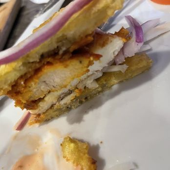 Ajo y Oregano - A Chimi Tostones Sliders (Pollo) cut In half to show the deliciousness - Dominican Near Me - Bronx, New York Ajo y Oregano - A Chimi Tostones Sliders (Pollo) cut In half to show the deliciousness - Dominican Near Me - Bronx, New York