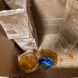 Jelly jars stacked end to end in cardboard, but no packing at ends, or between bottles.  Not shown, a ruptured bag of flour