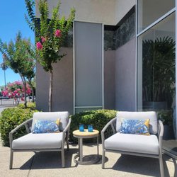 Harborside lounge chairs near entrance to store