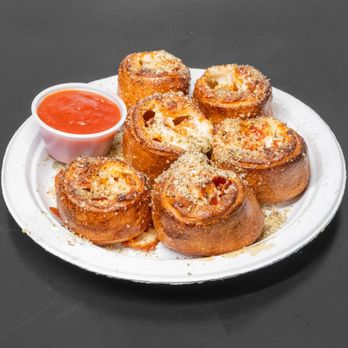 Happy Pappy’s - Pepp-n-Rolly - Peperoni and mozzarella roll, cut into 6 pieces, topped with parmesan, garlic and herbs. Served with marinara on the side. - Chicken Wings Near Me - Greenacres, Florida Happy Pappy’s - Pepp-n-Rolly - Peperoni and mozzarella roll, cut into 6 pieces, topped with parmesan, garlic and herbs. Served with marinara on the side. - Chicken Wings Near Me - Greenacres, Florida