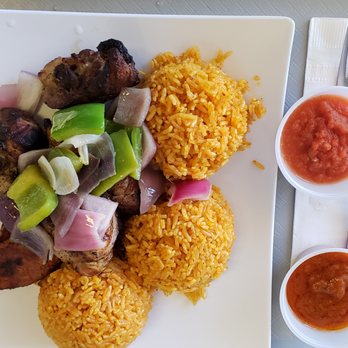 The Hunger Tamer - Chicken and Jollof with two sauces on the side. - African Near Me - Laurel, Maryland