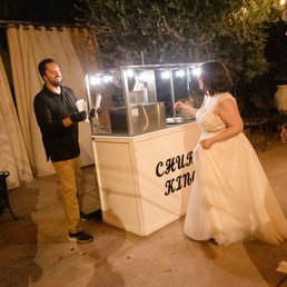 a man and a woman standing in front of a kiosk