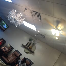 Busted looking ceiling fan next to a crystal chandelier. Interesting!