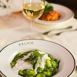 Felice Port Chester - Soft gnocchi coated in a vibrant green pesto sauce and topped with creamy white burrata and fresh basil...