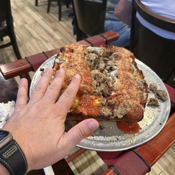 Genna Pizza - Detroit style pizza with hand for scale - it's big. - Pizza Near Me - Melbourne, Florida Genna Pizza - Detroit style pizza with hand for scale - it's big. - Pizza Near Me - Melbourne, Florida