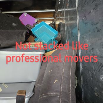 Ox Movers - The image shows a cluttered area with moving supplies, including a blue plastic container, a black bag, and a worn sofa, with overlaid red text. - Furniture Assembly Near Me