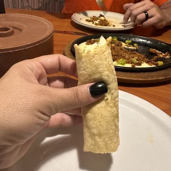 El Mex-Kal - a person eating a burrito - Mexican Near Me - Estes Park, Colorado El Mex-Kal - a person eating a burrito - Mexican Near Me - Estes Park, Colorado