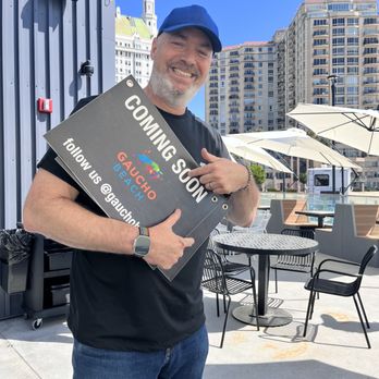 Gaucho Beach - Max holds the "coming soon" sign before its final place of retirement. - Sandwiches Near Me - Long Beach, California Gaucho Beach - Max holds the "coming soon" sign before its final place of retirement. - Sandwiches Near Me - Long Beach, California