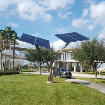 Solar Source - Solar Electric Art Sculpture powering a cell phone charger installed next to the adjacent park bench. - Solar Installation Near Me - Altamonte Springs, Florida Solar Source - Solar Electric Art Sculpture powering a cell phone charger installed next to the adjacent park bench. - Solar Installation Near Me - Altamonte Springs, Florida