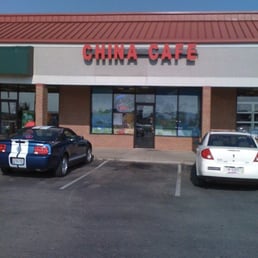 two cars parked in front of a chinese restaurant