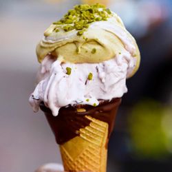 Luna Gelateria - Strawberry and pistachio gelato on a dipped cone from our chocolate fountain