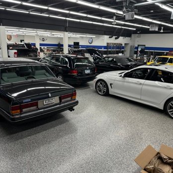 Dent Kraft PDR - A well-lit garage or showroom displays several luxury vehicles, including a classic black Rolls-Royce in the foreground and v... - Mobile Dent Repair Near Me - Eden Prairie, Minnesota Dent Kraft PDR - A well-lit garage or showroom displays several luxury vehicles, including a classic black Rolls-Royce in the foreground and v... - Mobile Dent Repair Near Me - Eden Prairie, Minnesota