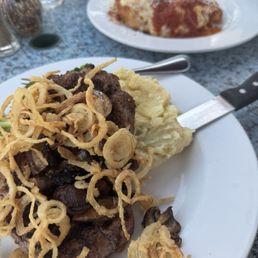 NY steak with onions and mushrooms on some mashed potatoes and broccoli NY steak with onions and mushrooms on some mashed potatoes and broccoli