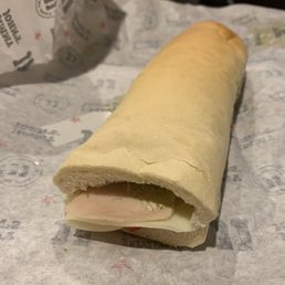 a sandwich wrapped in paper