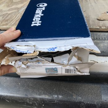 ProSource of Fort Worth - a hand holding a box of toilet paper - Flooring Near Me - Fort Worth, Texas