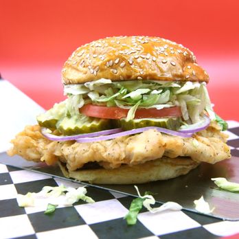 Cluck Norris - a chicken sandwich with lettuce and tomatoes - Chicken Shop Near Me - Columbus, Ohio Cluck Norris - a chicken sandwich with lettuce and tomatoes - Chicken Shop Near Me - Columbus, Ohio