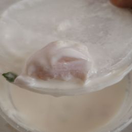 Piece of Raw chicken in Raita.