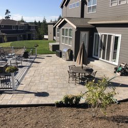 Transblue - Spokane - block retaining wall, paver patio with adjacent black aluminum railing composite deck