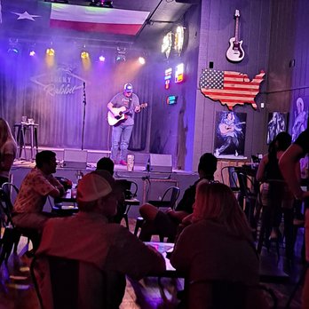 Lucky Rabbit - a man playing a guitar on stage - Music Venues Near Me - Jonestown, Texas Lucky Rabbit - a man playing a guitar on stage - Music Venues Near Me - Jonestown, Texas
