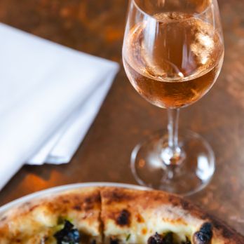 Pecan Square Cafe - a pizza and a glass of wine - New American Near Me - Austin, Texas