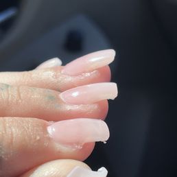 Unfinished filing. Uneven shapes. Didn't finish cycle of gel so polish came out tacky. Acrylic stuck to skin.