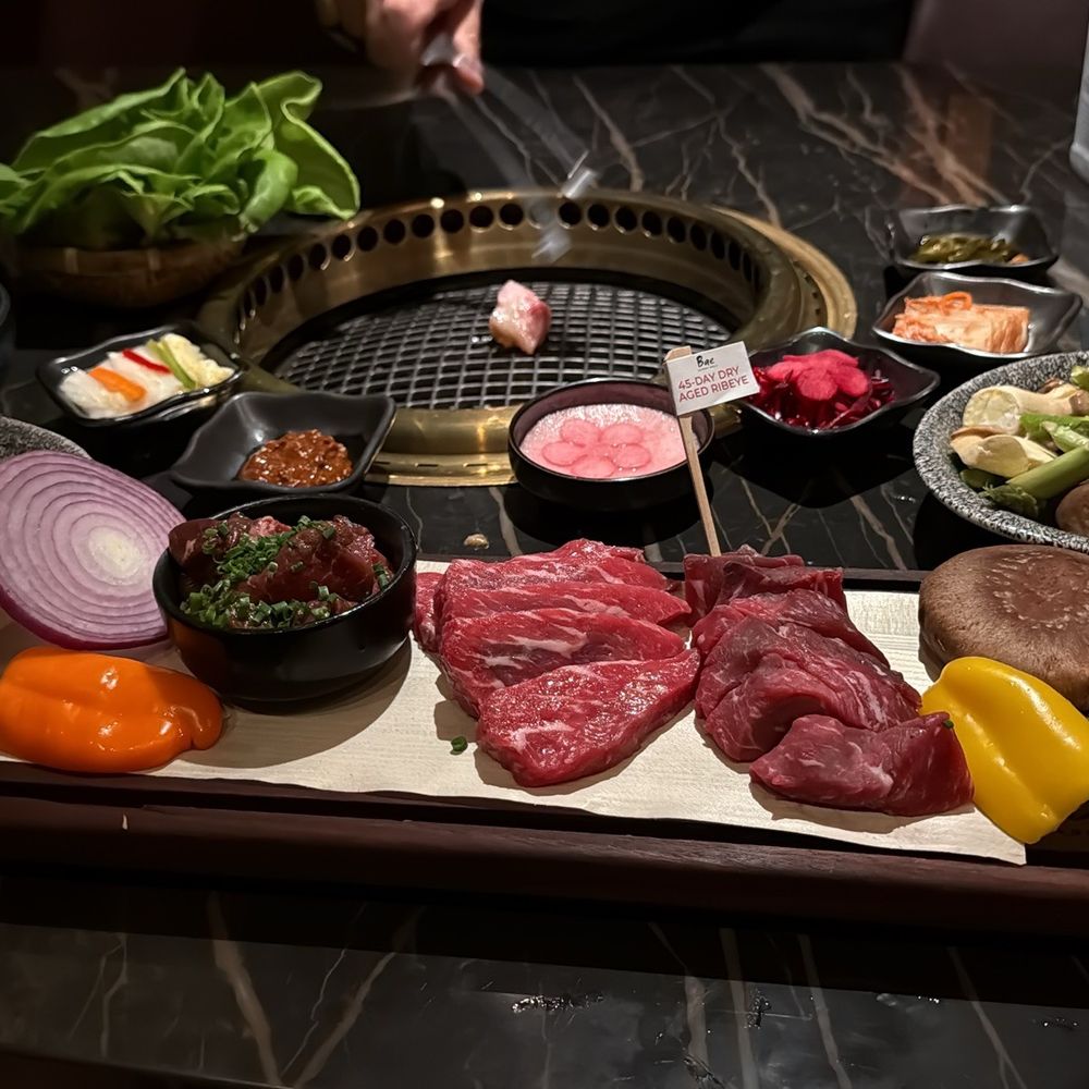 Bae Korean Grill - Bae Feast with vegetable rice and side asparagus and mushrooms. Waygu fat on the grill to prepare the surface. - Korean Near Me - Hollywood, Florida