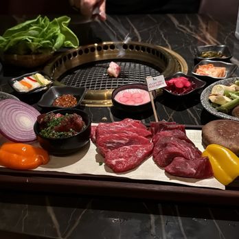 Bae Korean Grill - Bae Feast with vegetable rice and side asparagus and mushrooms. Waygu fat on the grill to prepare the surface. - Korean Near Me - Hollywood, Florida