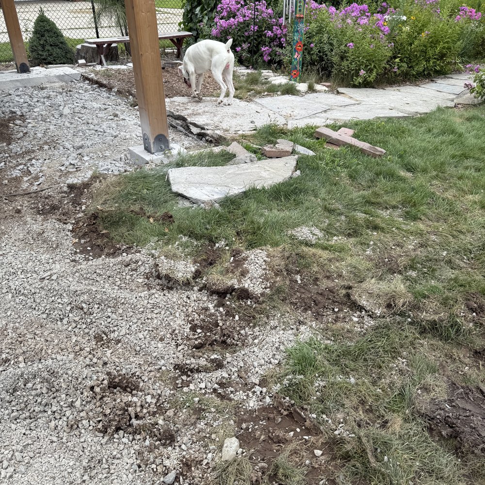 Valley Peak Construction - The flagstone pathway used to be where the gravel is. Beyond that is after the cement was broken up with the jack hammer and never removed - Masonry/Concrete Near Me - Appleton, Wisconsin