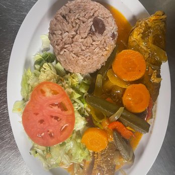The New Blue Mountain Restaurant - Brown stew Fish with Rice& Peas and Salad. - Caribbean Near Me - Lauderhill, Florida The New Blue Mountain Restaurant - Brown stew Fish with Rice& Peas and Salad. - Caribbean Near Me - Lauderhill, Florida