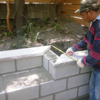 Excellent General Contracting - Worker taking measurements for retaining wall - General Contractors Near Me - Brooklyn, New York Excellent General Contracting - Worker taking measurements for retaining wall - General Contractors Near Me - Brooklyn, New York