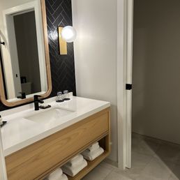Sink with towels stored on shelf. Sink with towels stored on shelf.
