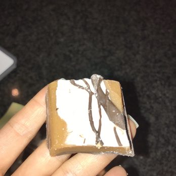 Mrs Mason's - a hand holding a piece of cake - Candy Stores Near Me - Royal Oak, Michigan